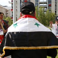 Un citoyen syrien attend pour être pris en photo avec la torche olympique à Londres